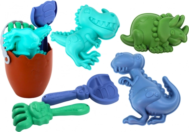 Piesková sada dinosauri s vedrom v tvare vajca, lopatkou, hrabľami a formičkami