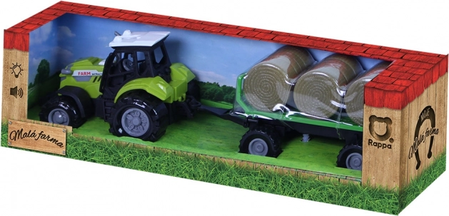 Traktor so zvukom a svetlom s vlečkou a balíkmi slamy