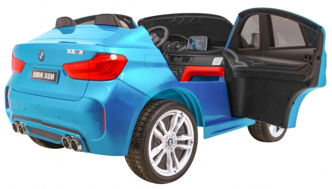 BMW X6M XXL pro 2 deti Modrá farba + Pilot + Eco koža + Bezpečnostné pásy + Pomalý štart + MP3 + LED