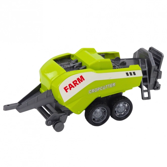 Červený traktor s nakladačom a balíkovačom