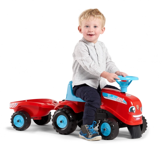 Odstrkovadlo - traktor Go Farm červené s volantom a vlečkou