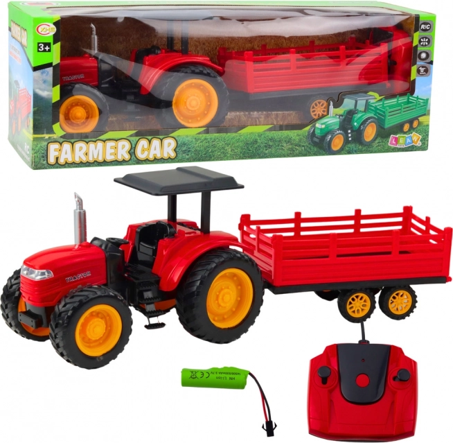 Diaľkovo ovládaný farmársky traktor s prívesom červený