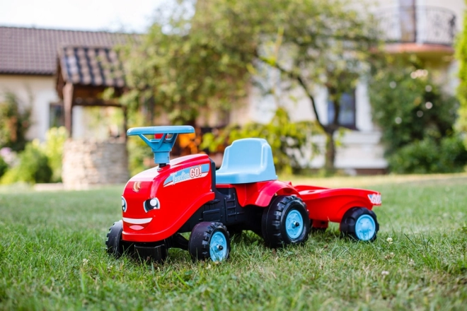 Odstrkovadlo - traktor Go Farm červené s volantom a vlečkou