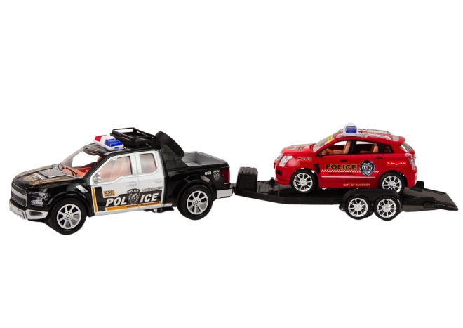Dve policajné vozidlá s odťahovým prívesom