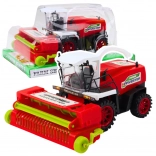 Červený poľnohospodársky kombajn s pohonom